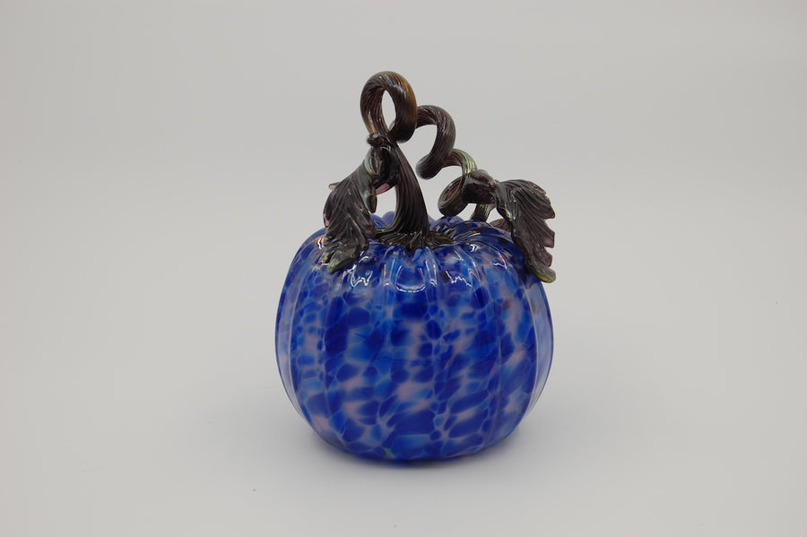 Three blue glass pumpkins with decorative stems on a white background