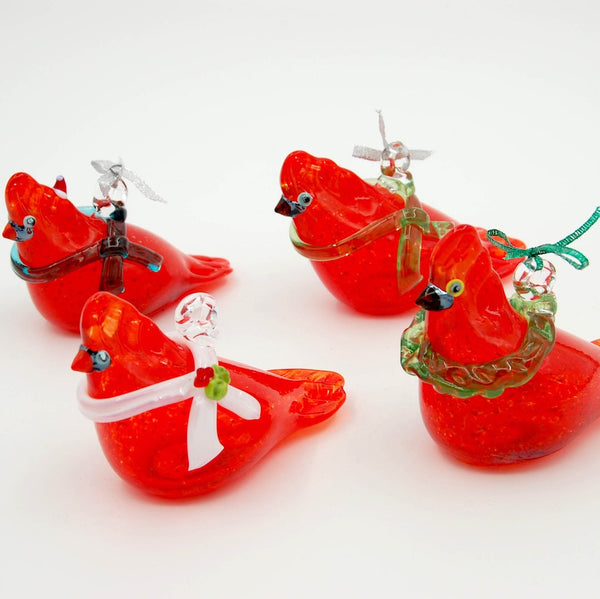 Set of red glass birds with decorative elements on a white background