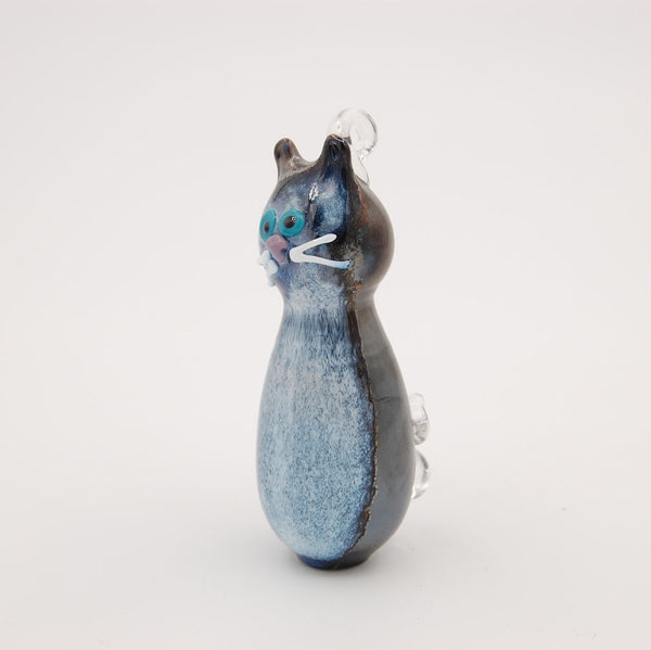 Cat-shaped glass ornament on a white background