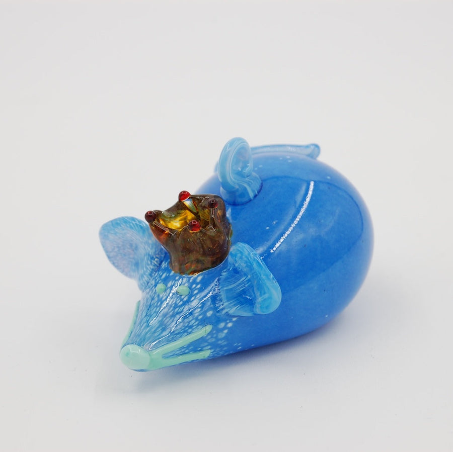 Three blown glass mice ornaments in orange, blue, and red on a white background