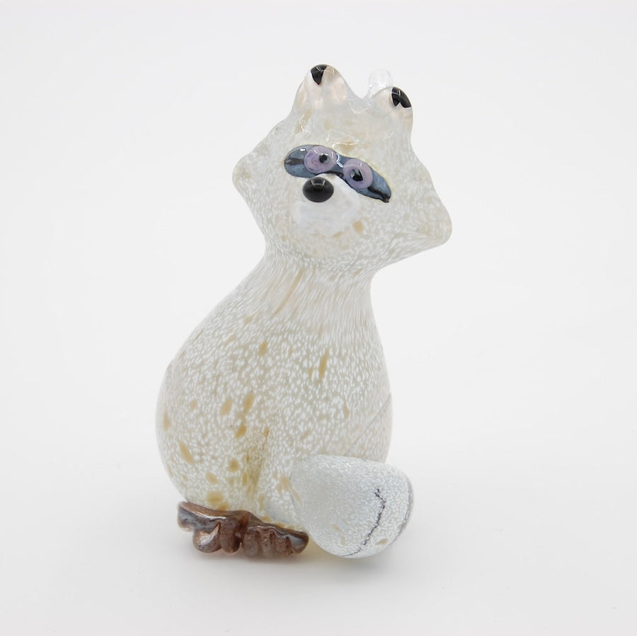 white glass raccoon ornament on a white background