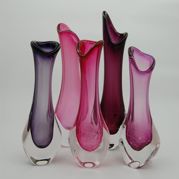 glass vases with purple and pink hues on a white background