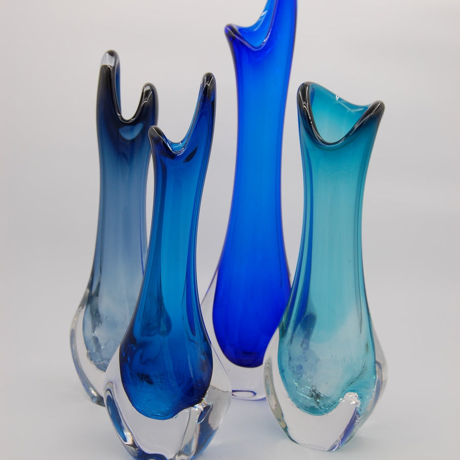 glass vases with purple and pink hues on a white background